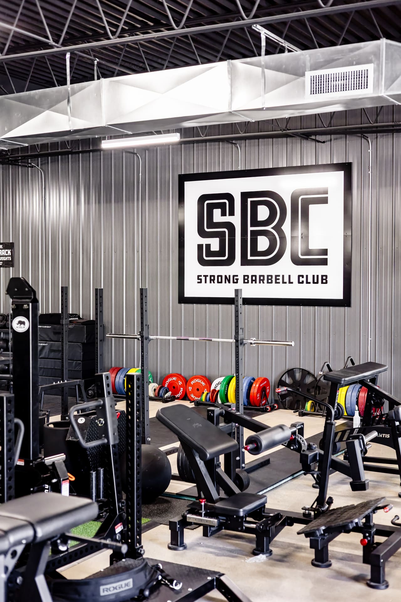 Squat racks and weight plates at Strong Barbell Club in Manhattan, Kansas